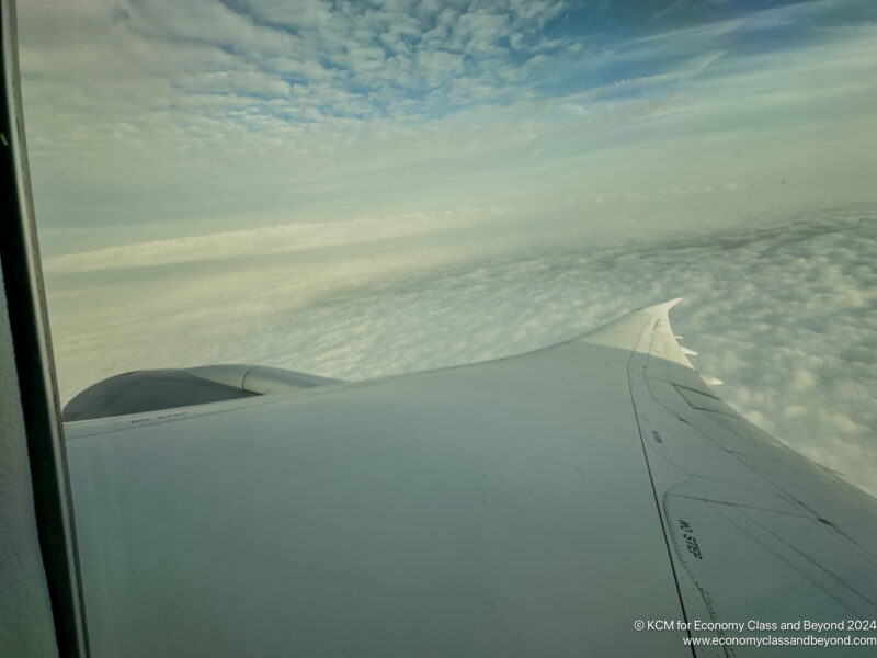 an airplane wing above the clouds