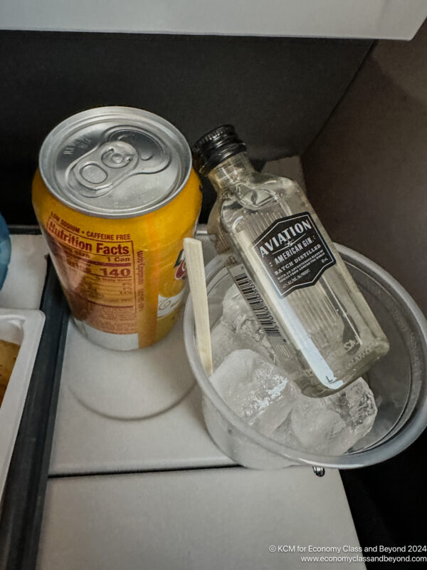 a can and a bottle of alcohol in a bucket