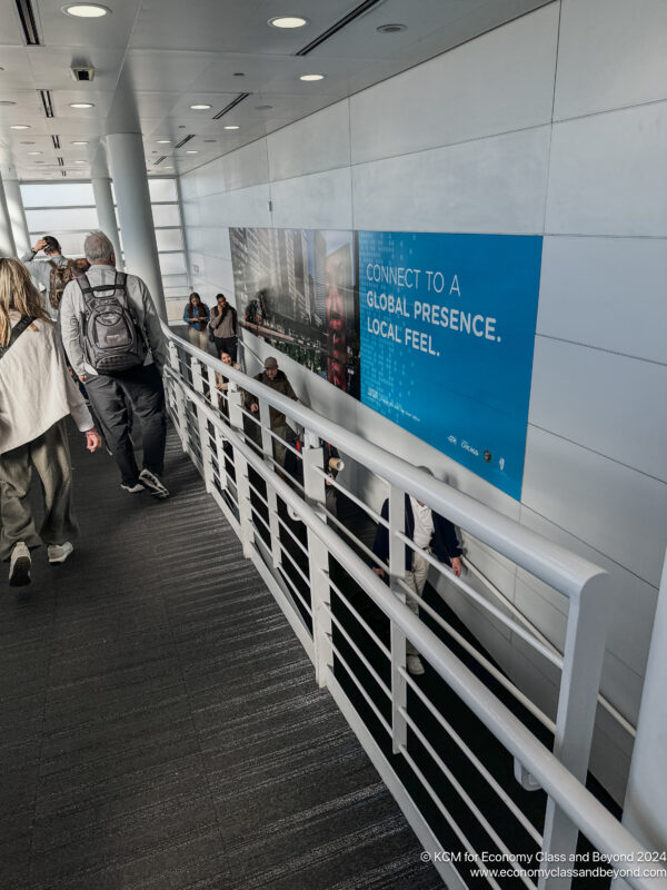 a group of people walking down a walkway