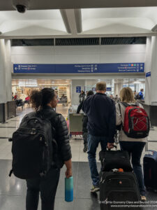 people walking with luggage in an airport