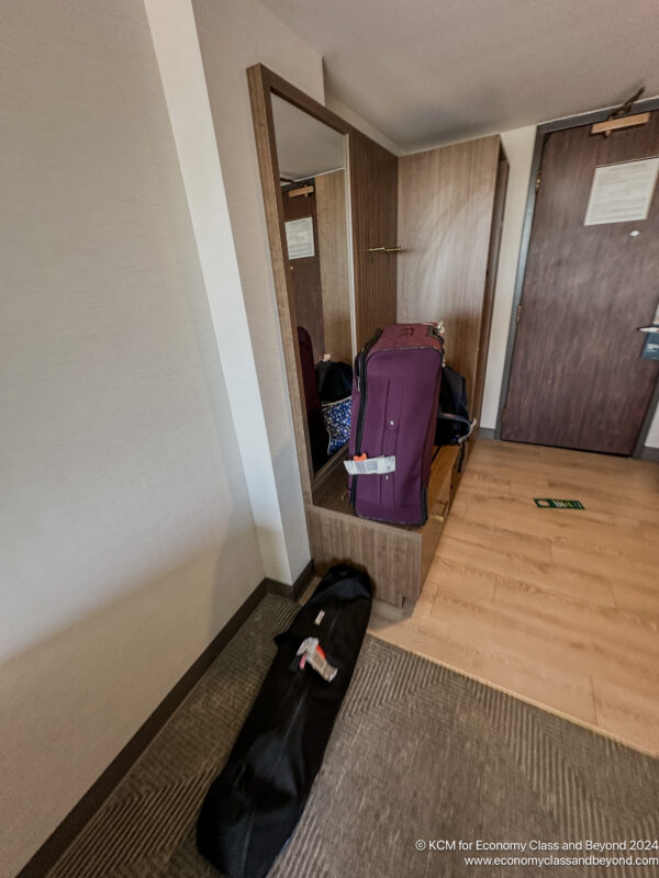 a suitcase on a shelf in a room