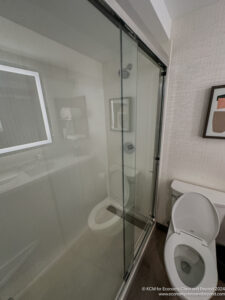 a bathroom with a glass shower door
