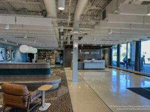 a lobby with a reception desk and a large window