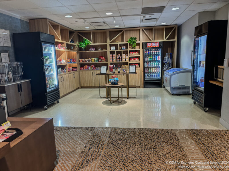 a room with shelves of beverages and a coffee machine