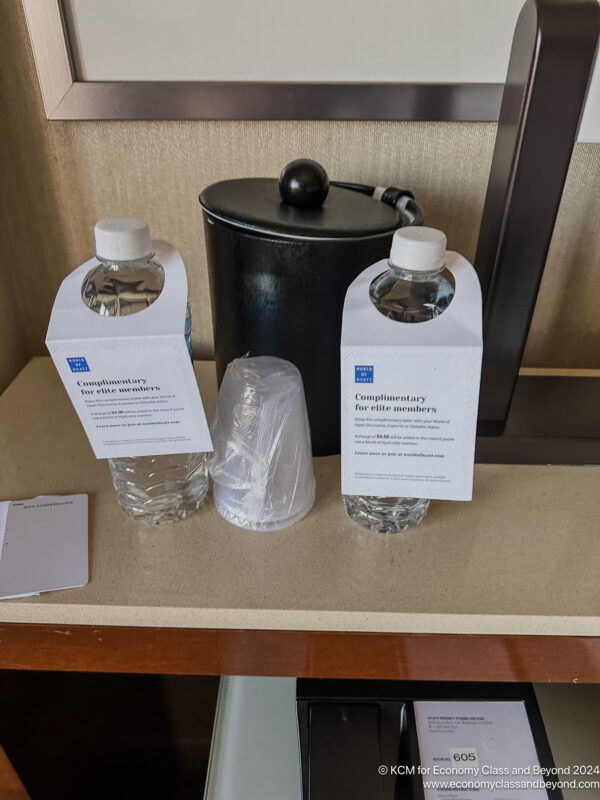 a group of water bottles and a container on a table