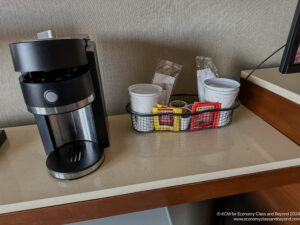 a coffee maker and coffee cups on a counter