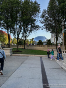 a group of people walking on a sidewalk