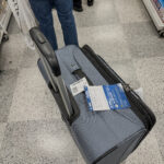 a suitcase with a handle and a tag on it