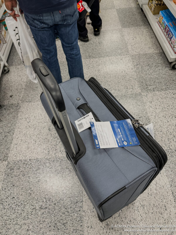 a suitcase with a handle and a tag on it