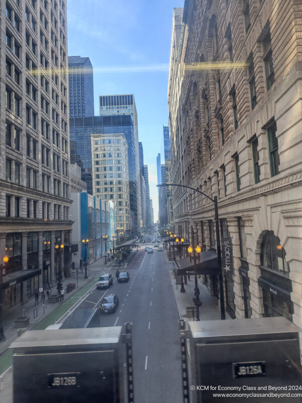 a street with cars and buildings in the background