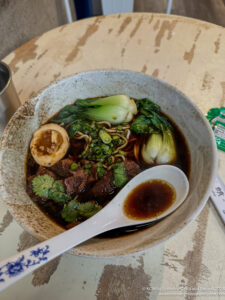 a bowl of soup with meat and vegetables