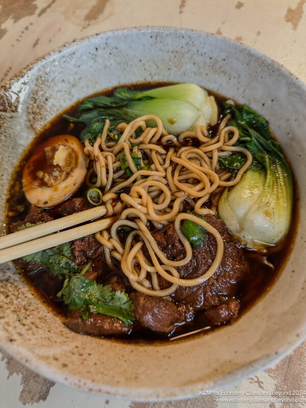 a bowl of soup with meat noodles and vegetables