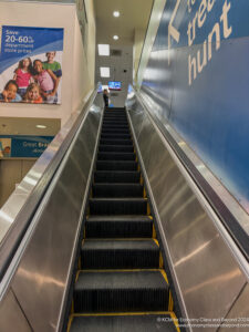 a person standing on an escalator