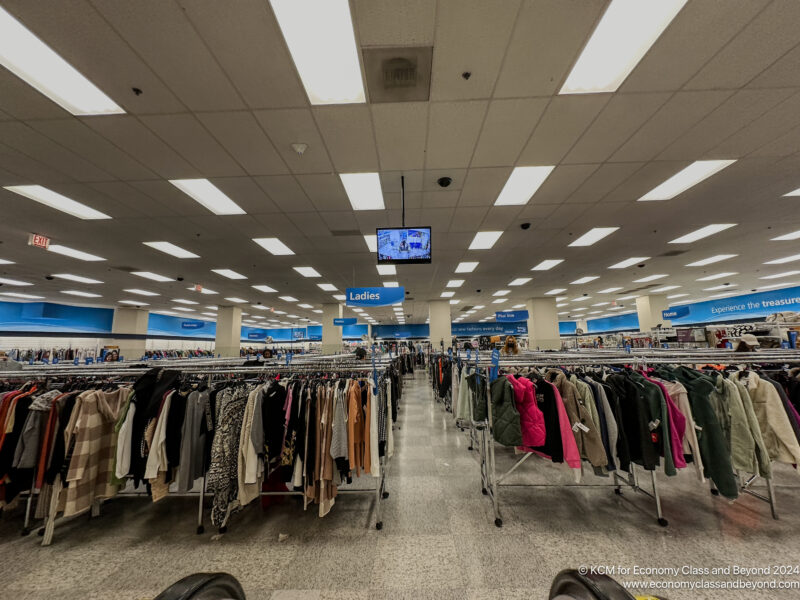 a room with a large group of clothes on swingers