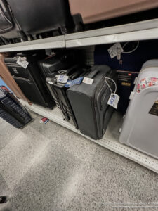 a group of luggage on a shelf