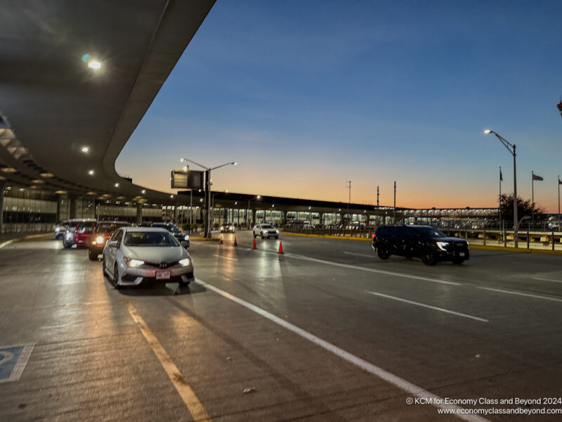 cars on a road with a bridge over it