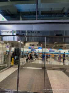 a glass door with people walking around