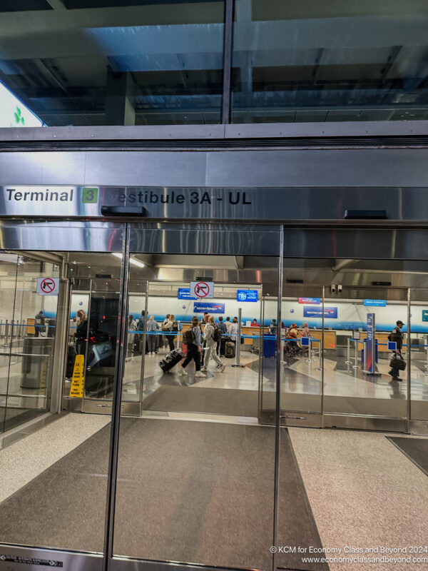 a glass door with people walking around