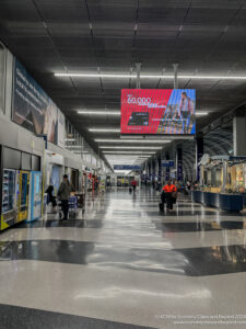 a large airport terminal with people walking