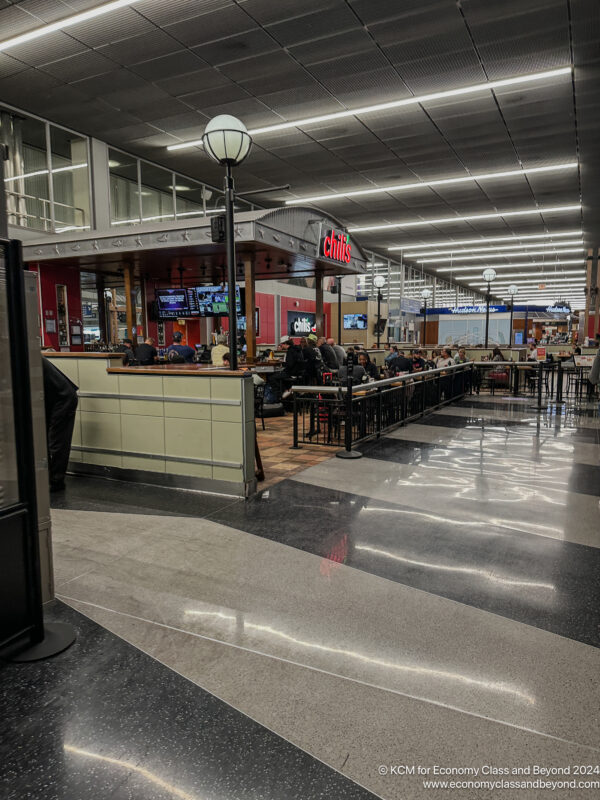 a group of people sitting at tables in a restaurant