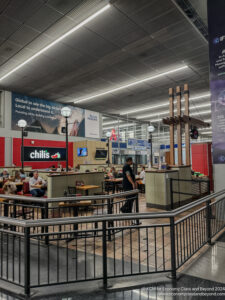 people sitting at tables in a large building