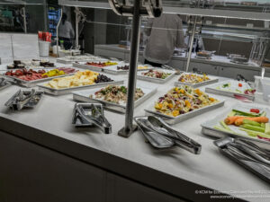 a buffet table with many trays of food