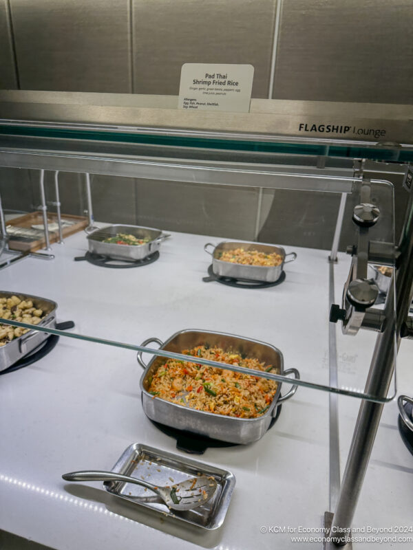 a group of pans of food in a glass case