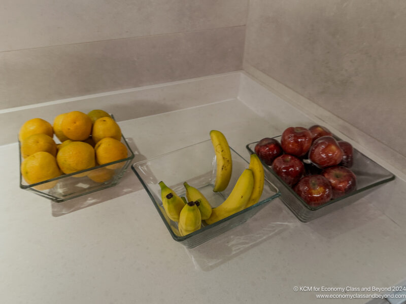 a group of glass bowls of fruit