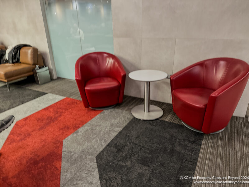 a red chairs and a table in a room