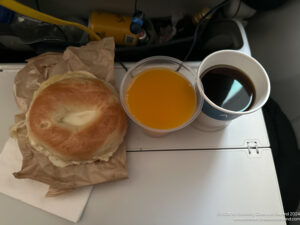 a bagel and coffee on a tray