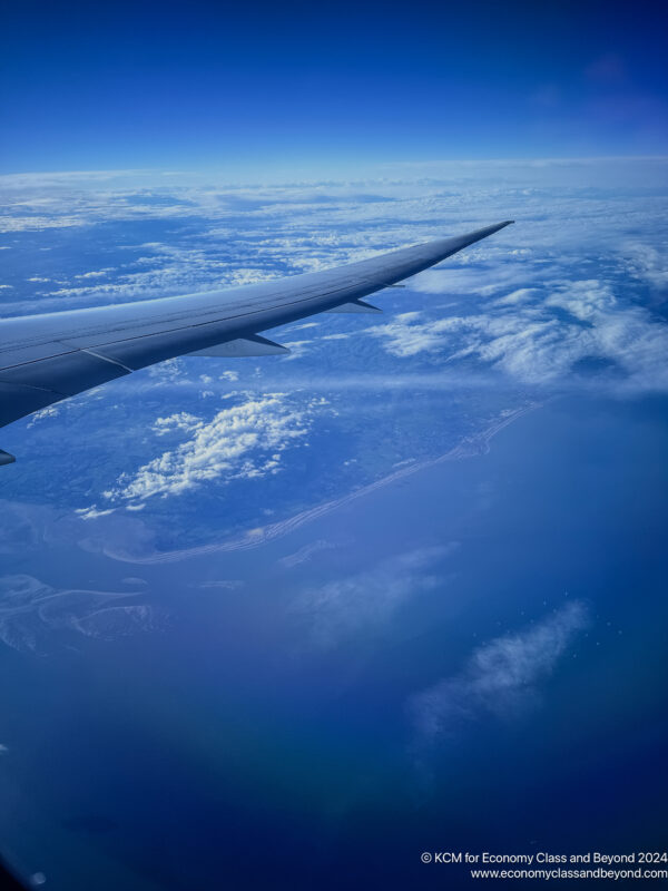 an airplane wing above the clouds