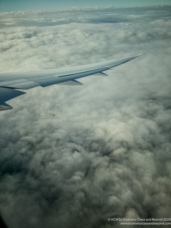 an airplane wing above clouds