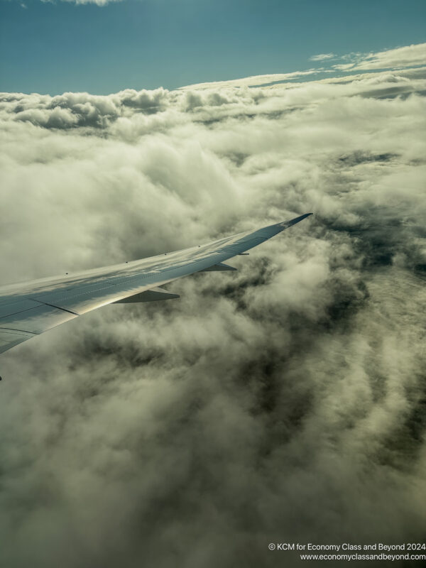 an airplane wing above clouds