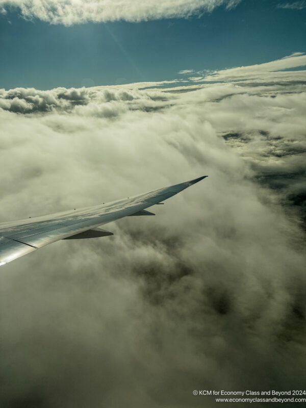 an airplane wing above clouds