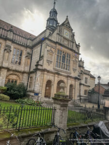 a building with a fence and grass