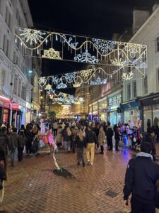 a crowd of people walking on a brick street