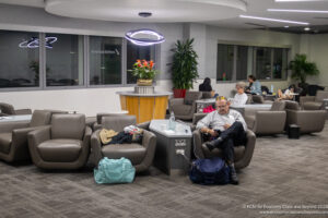 a man sitting in a chair in a lobby