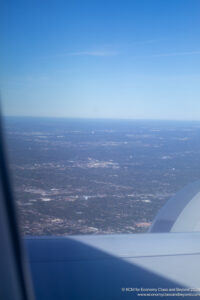 an airplane wing and a city