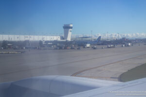 an airport with airplanes and a tower