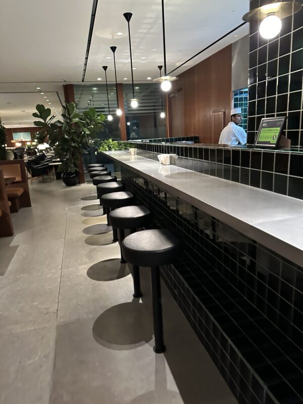 a restaurant with a counter and stools