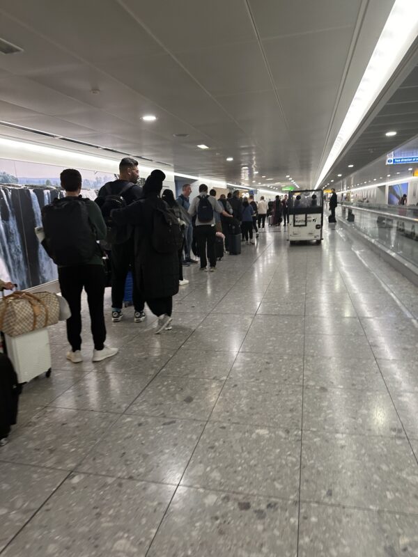 a group of people in a hallway with luggage