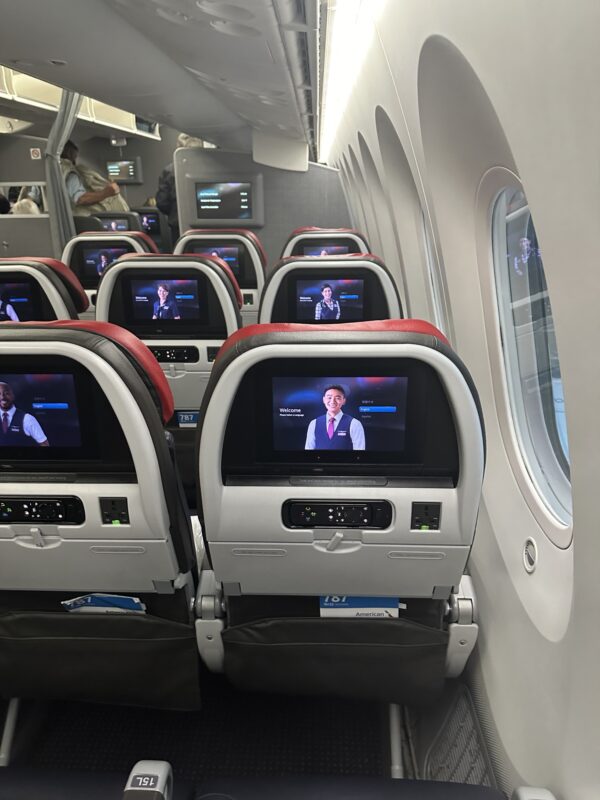 a row of seats with tvs on the back