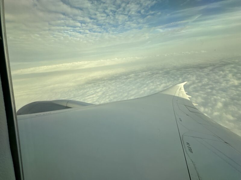 an airplane wing above clouds