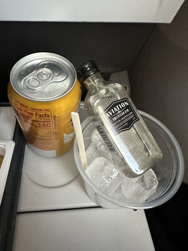 a can and a bottle of alcohol in a bucket