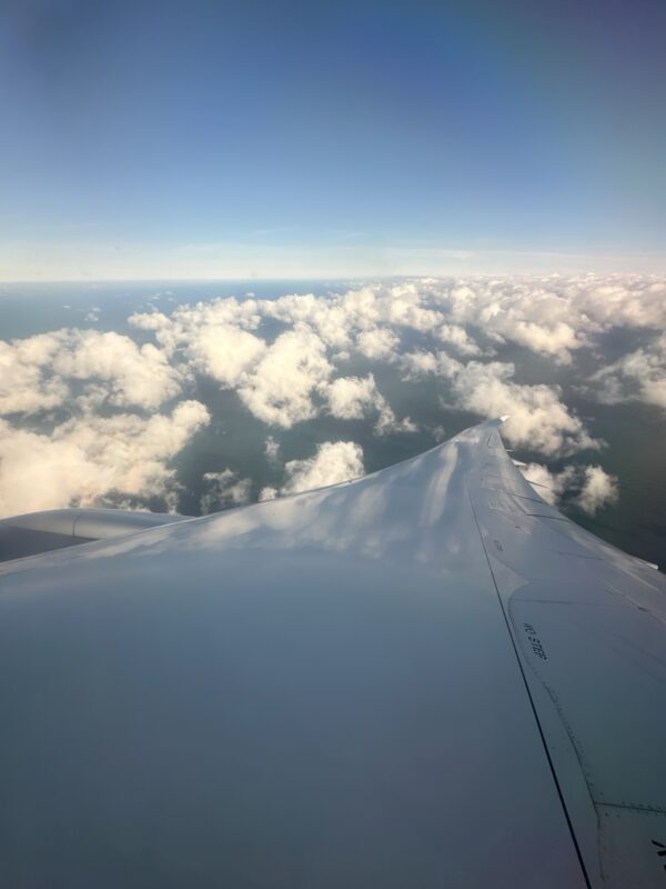 an airplane wing and clouds