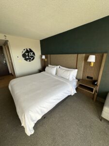 a bed with white sheets and lamps in a hotel room