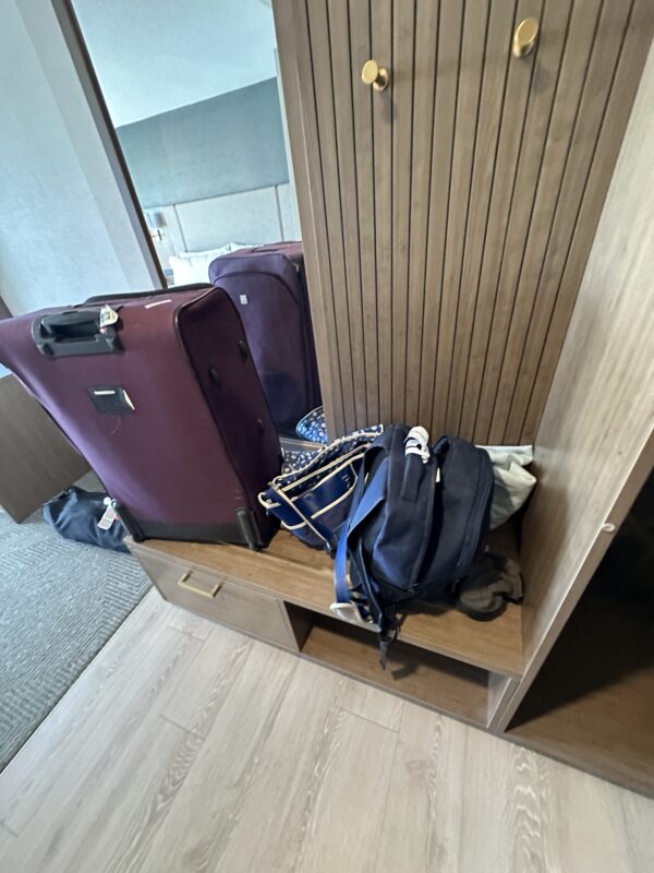 a group of luggage on a shelf