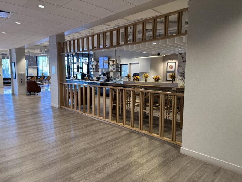 a room with a wood floor and a wood railing