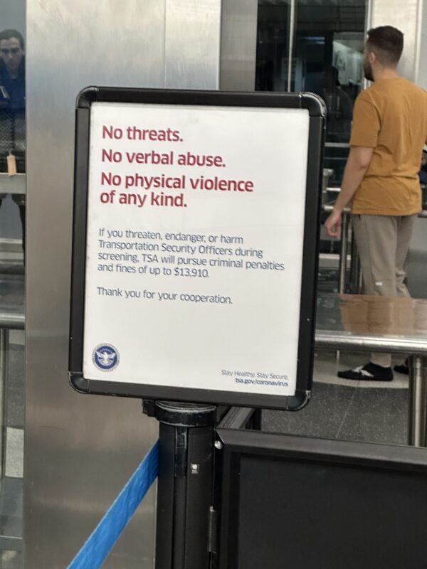 a sign with red text and blue text on it