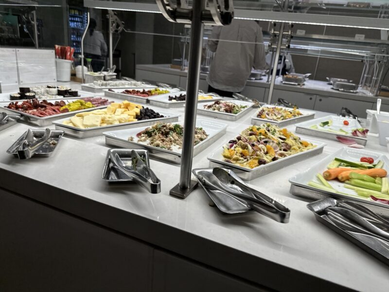 a buffet table with many trays of food